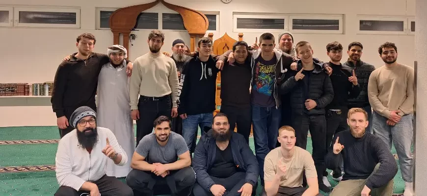 Group of young men gathered inside a mosque in Norway for a Dawah event.